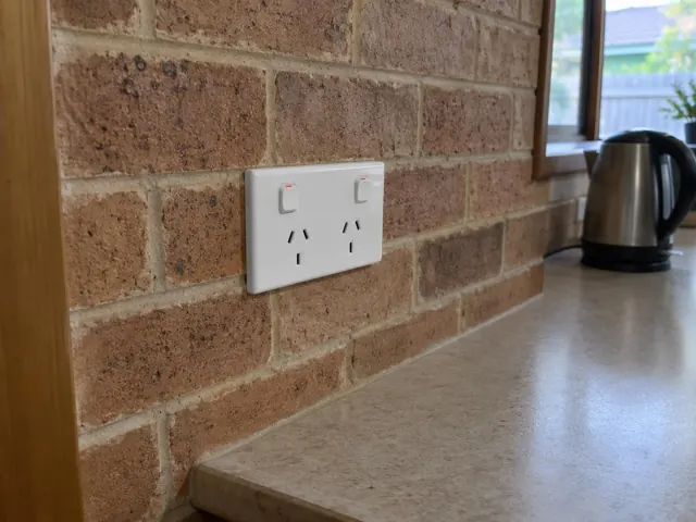 Double power point on a brick kitchen wall above a benchtop in Killarney Vale